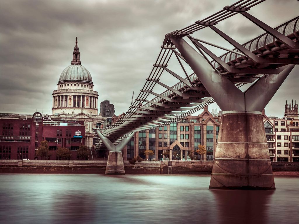 View of St Paul's Cathedral and Millennium Bridge from river thames, London, UK