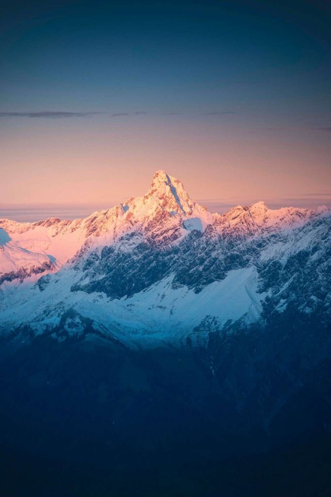 Avondlicht op besneeuwde bergtop