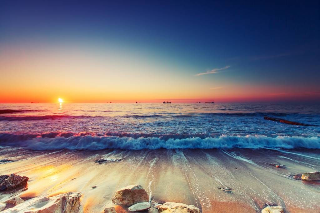 Behang met een zonsondergang boven zee